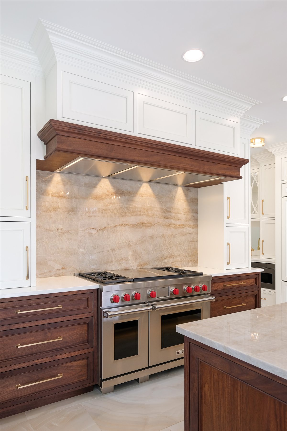 Range with a walnut-trimmed hood, Waxhaw kitchen