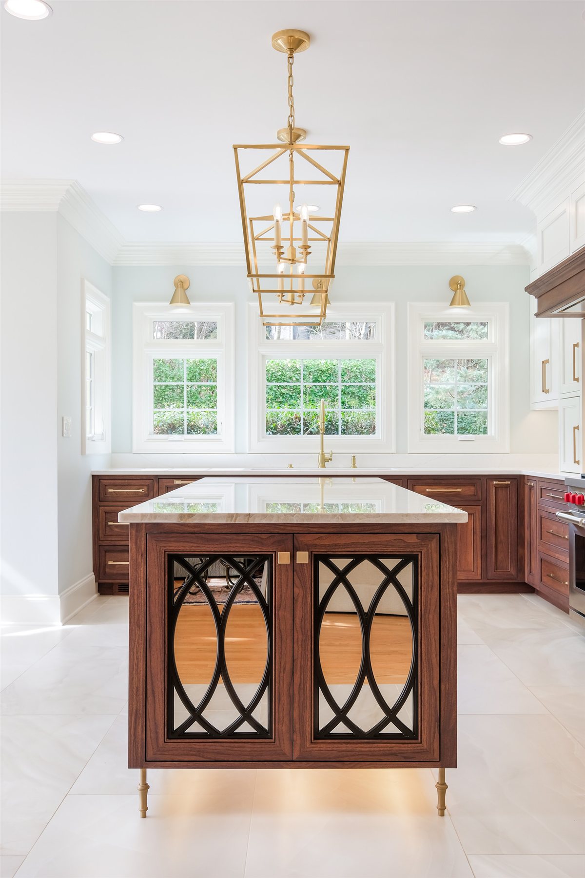 Walnut island with arched glass doors under a brass lantern, Waxhaw kitchen