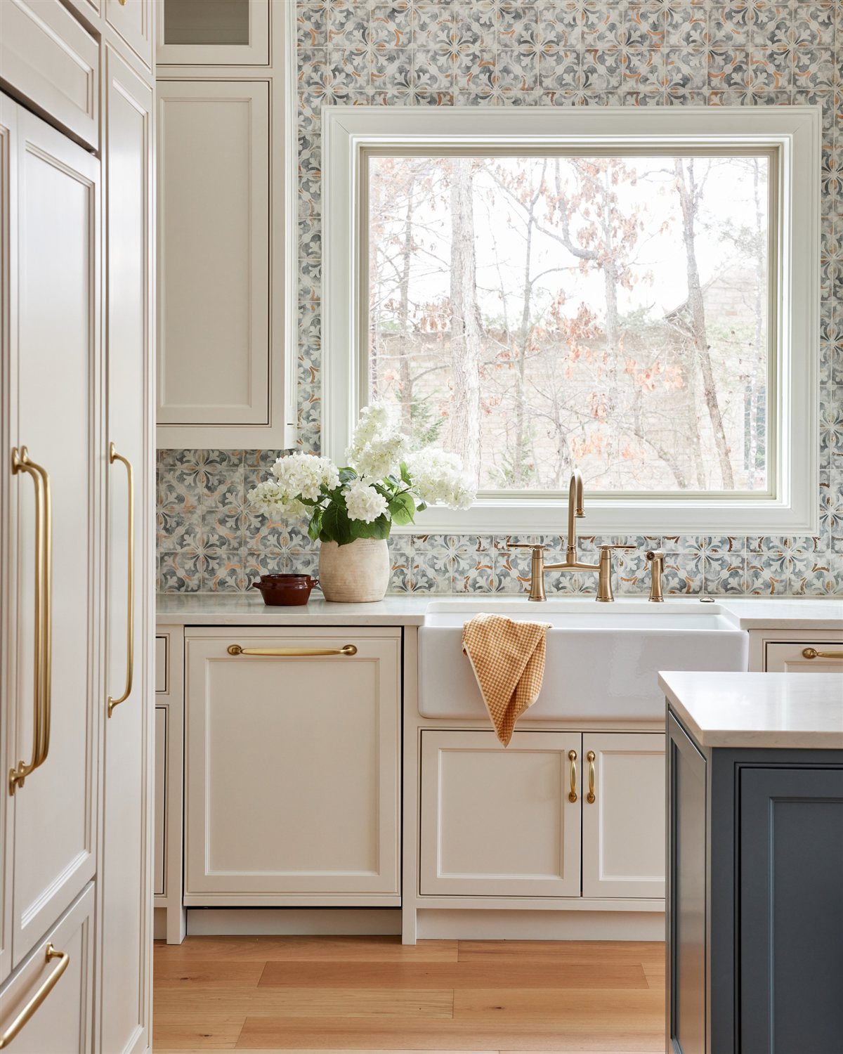 Patterned tile backsplash above a white sink cabinet, Waxhaw renovation