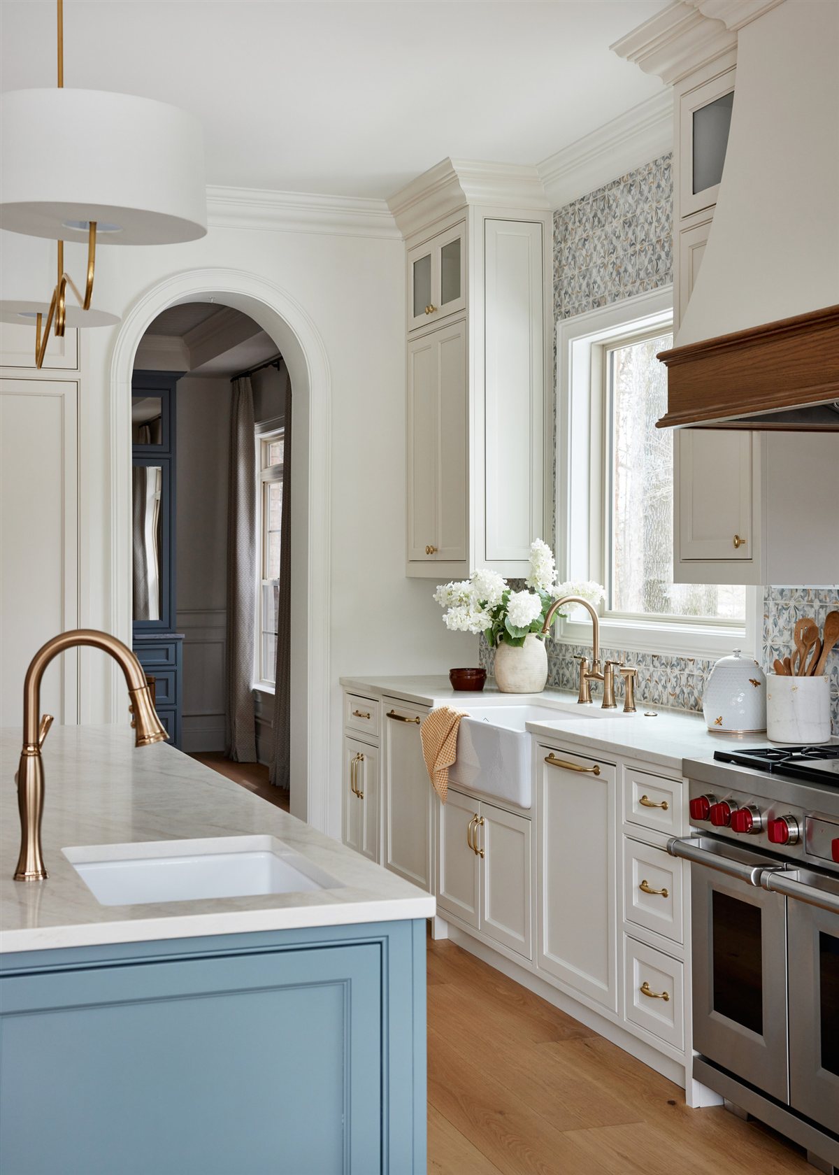 Kitchen sink run with a brass faucet and range beyond, Waxhaw renovation