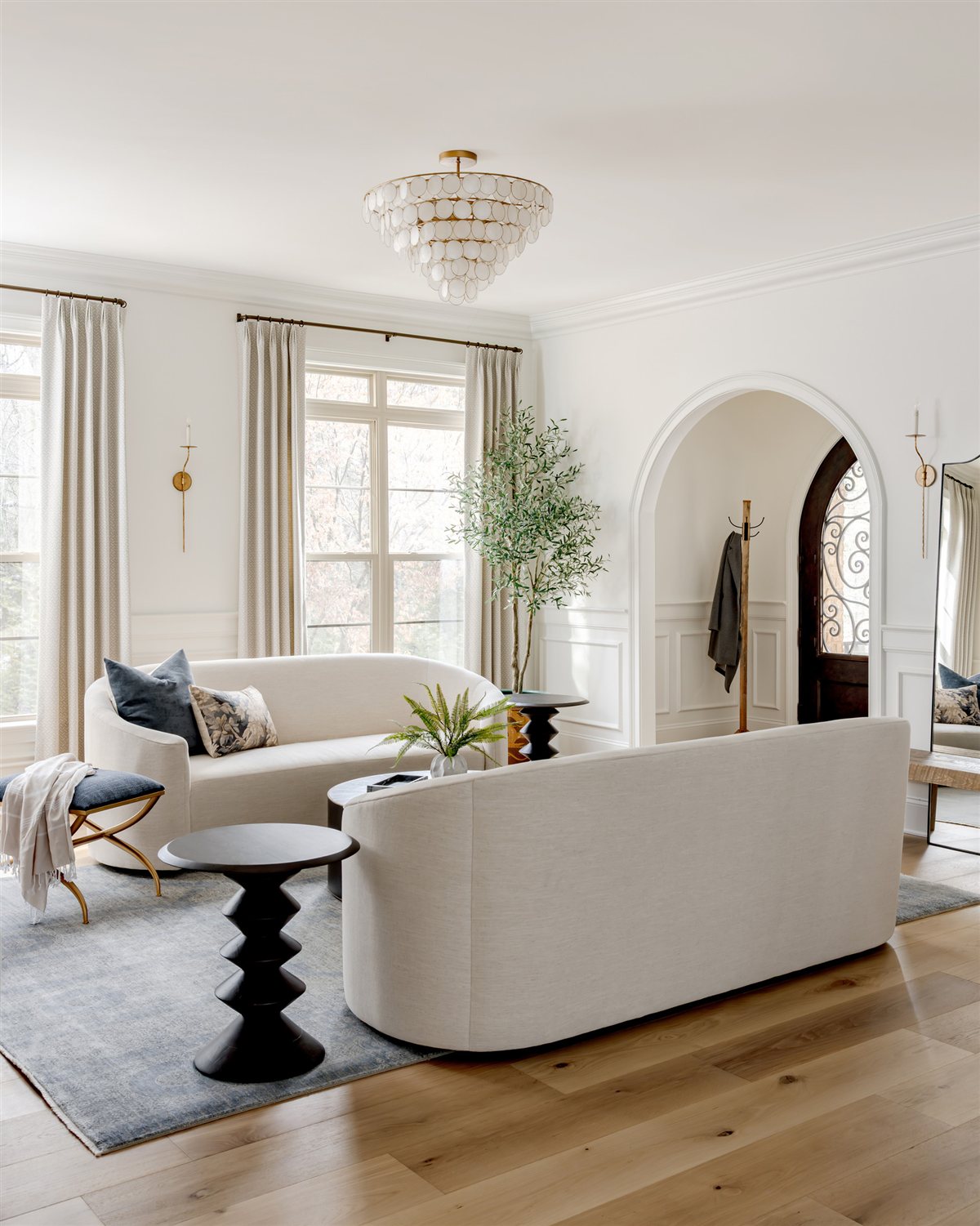 Living room with tall windows and a sculptural side table, Waxhaw renovation