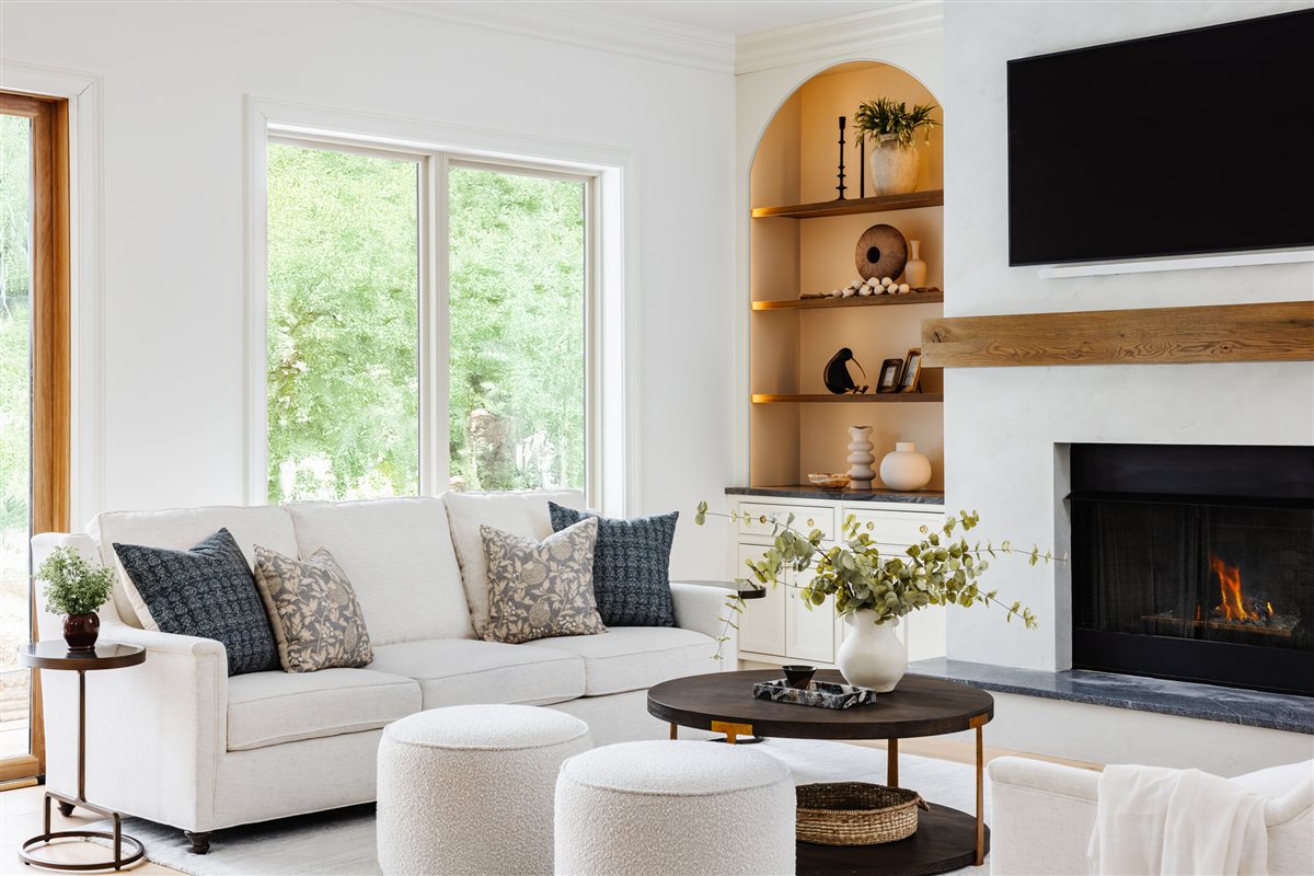 Fireplace wall with a wood mantel, arched built-ins and television, Waxhaw renovation