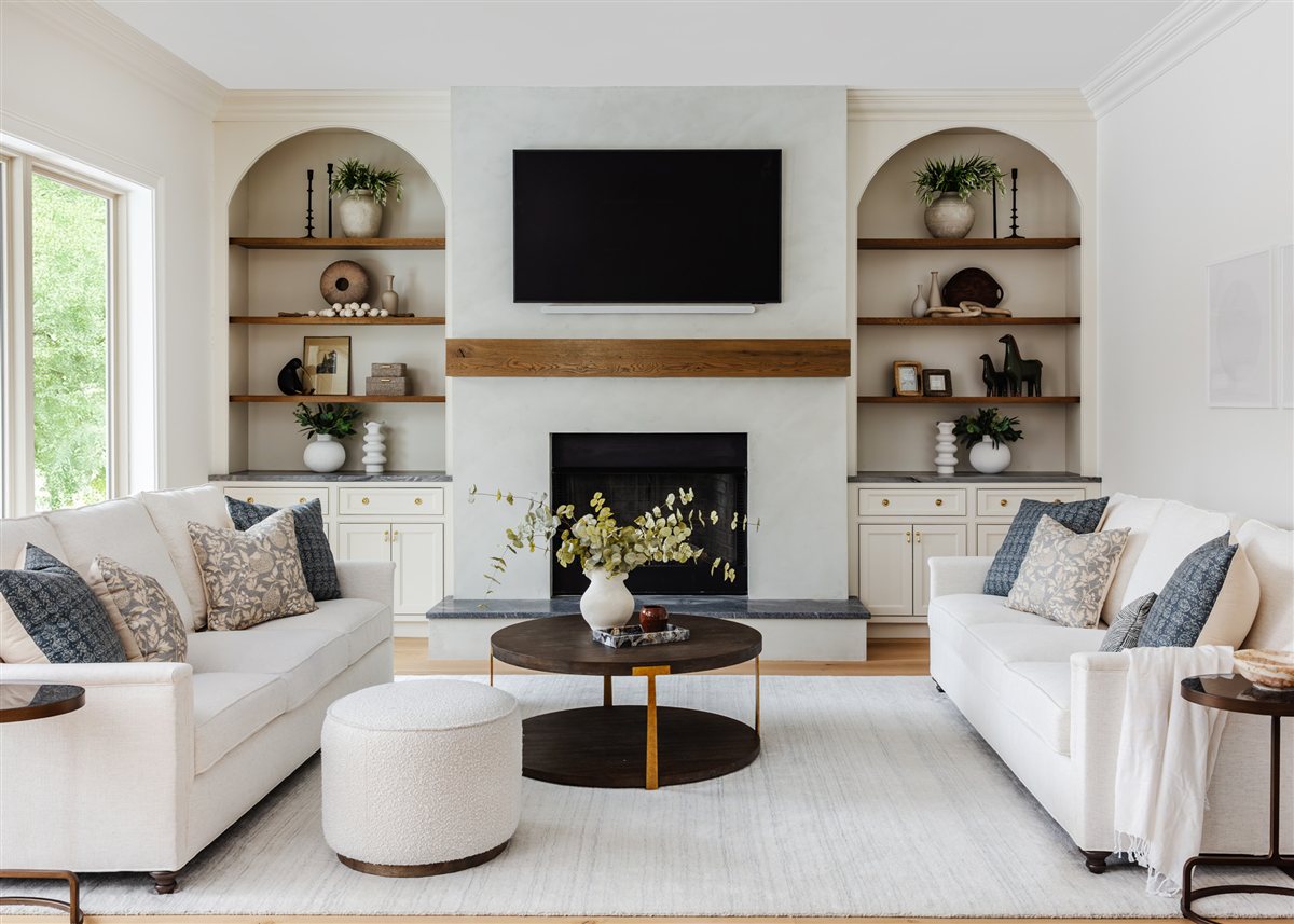 Family room with white sofas and arched built-in shelves, Waxhaw renovation