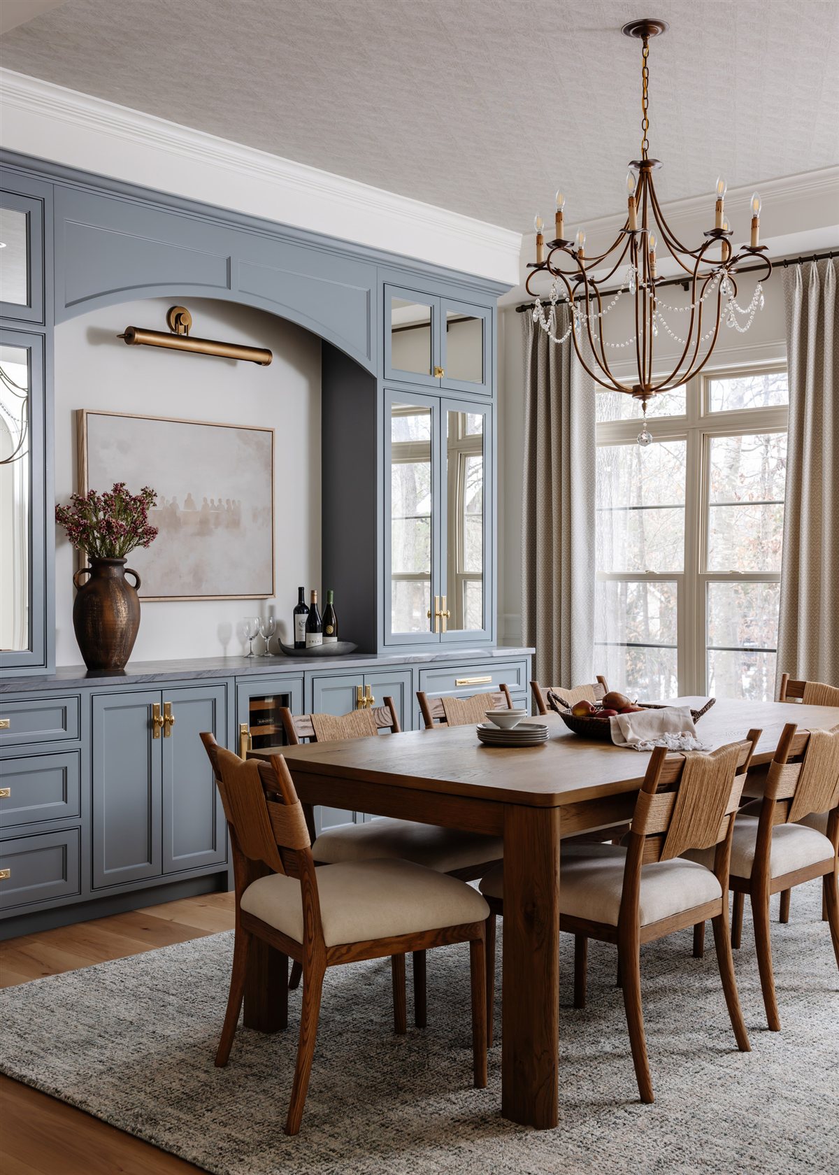 Dining room with blue built-in cabinetry and a wood table, Waxhaw renovation