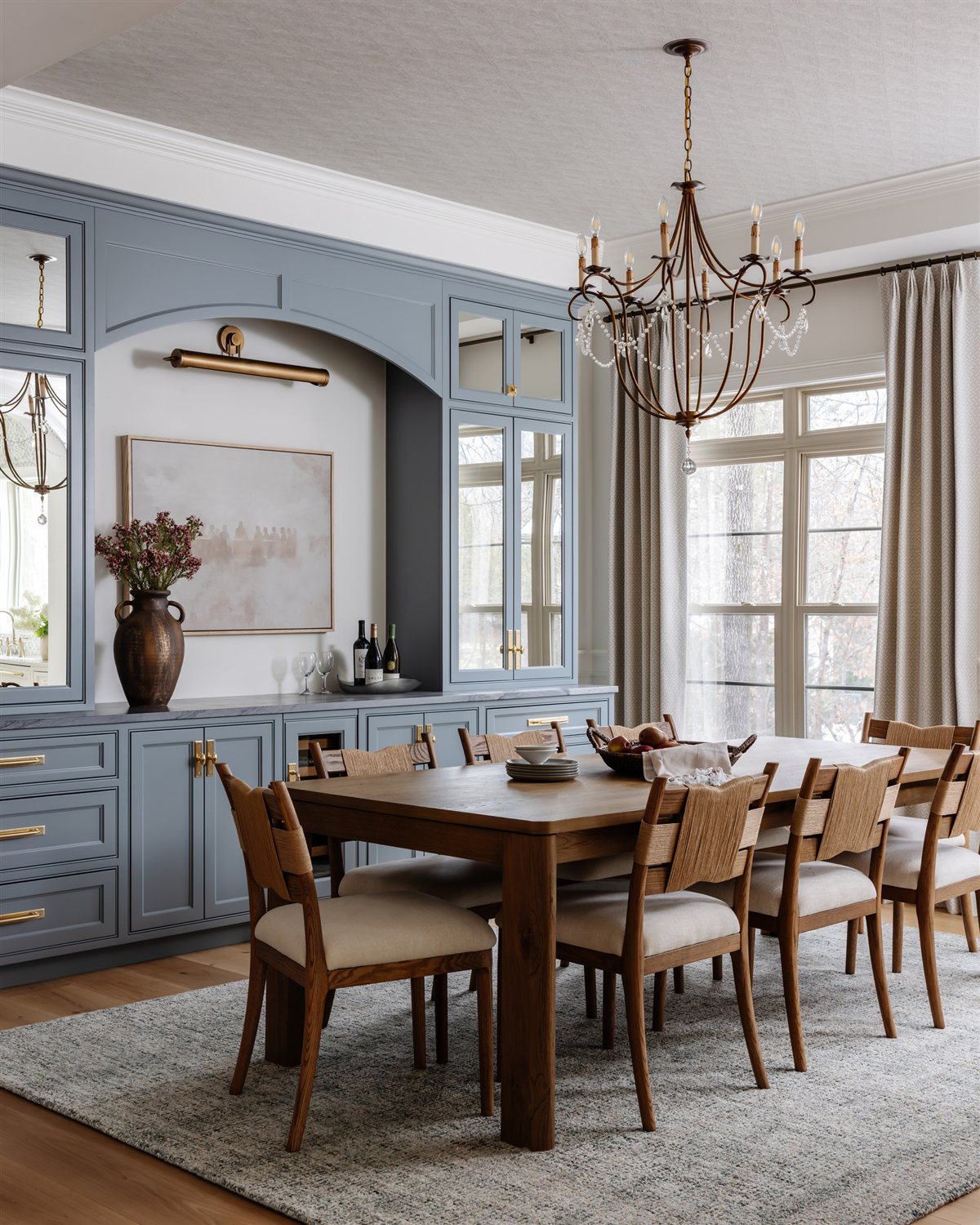 Dining room with a beaded chandelier and blue built-ins, Waxhaw renovation