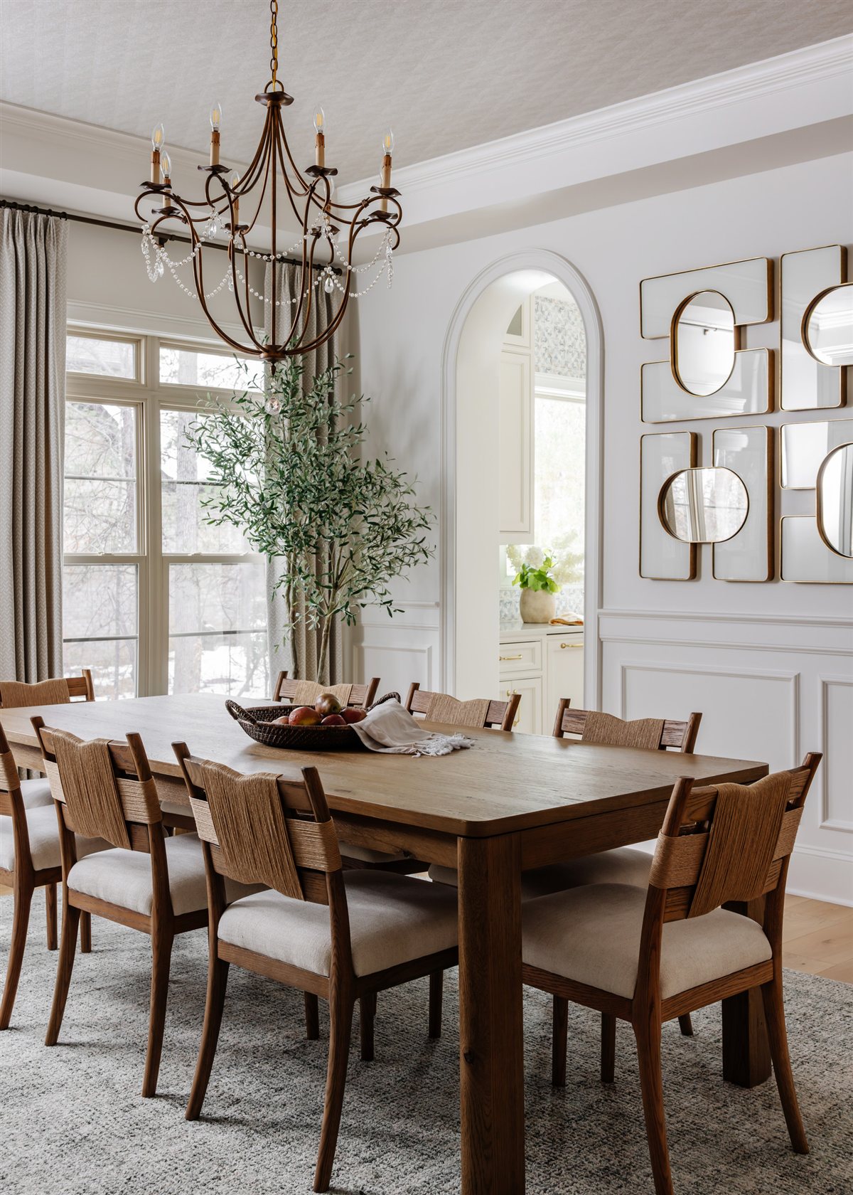 Dining room with a wood table beneath a chandelier, Waxhaw renovation