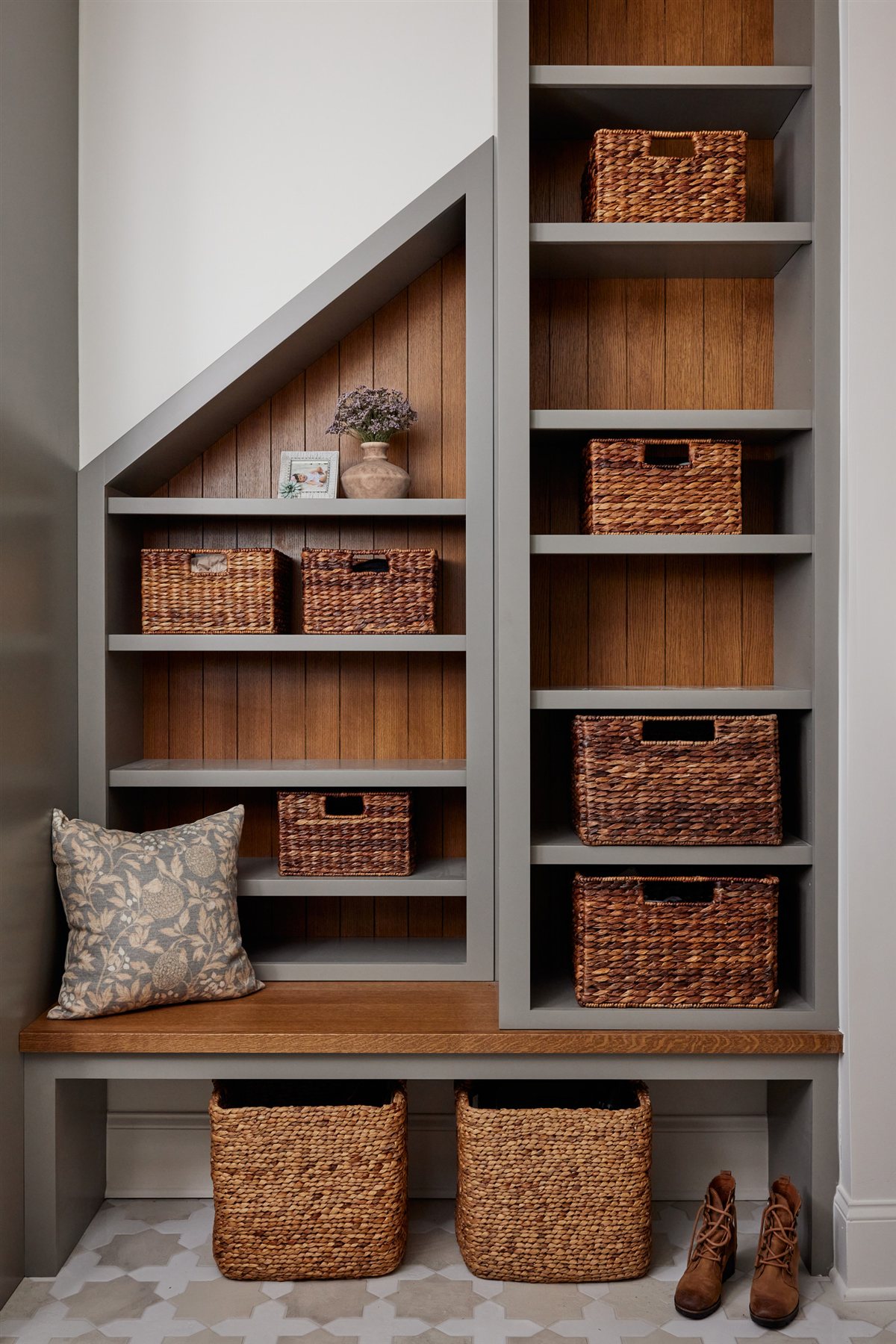 Under-stair built-in with wood shelves and baskets, Waxhaw renovation