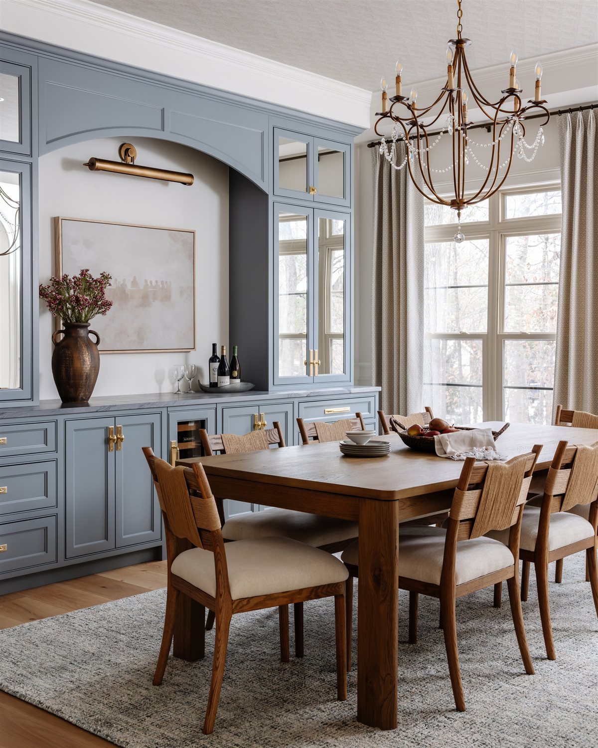 Dining room with blue built-in cabinetry and chandelier, Waxhaw renovation