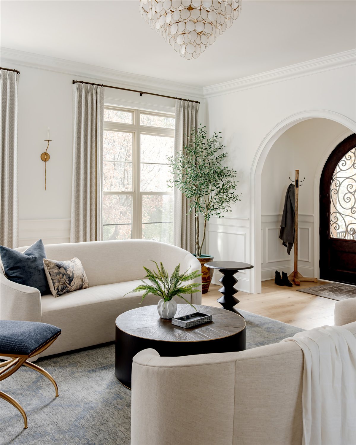 Living room with a curved sofa beside the front entry, Waxhaw renovation