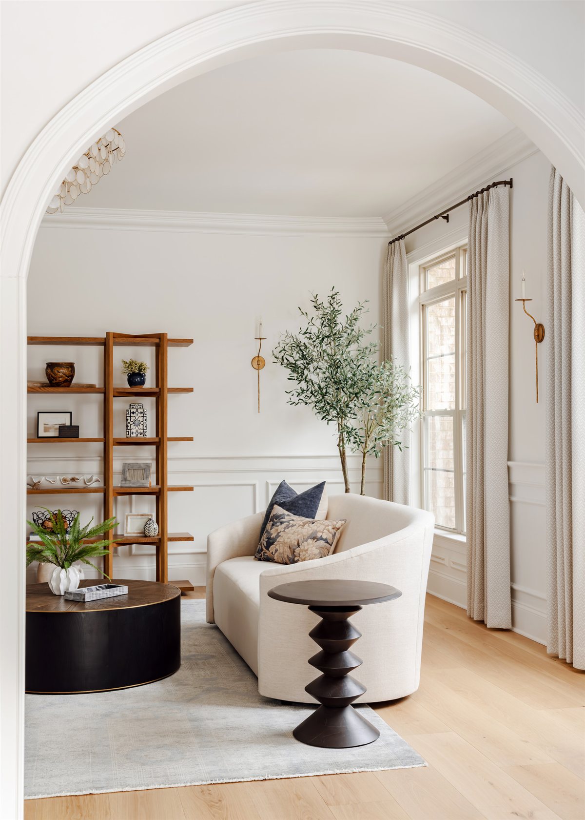 Arched sitting room with swivel chairs and built-in shelves, Waxhaw renovation