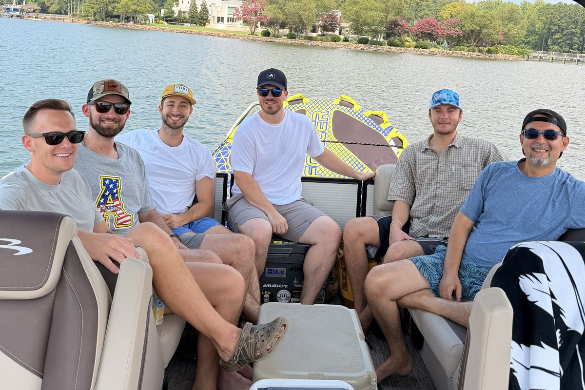The Revival team on a pontoon boat during a summer outing on Lake Norman