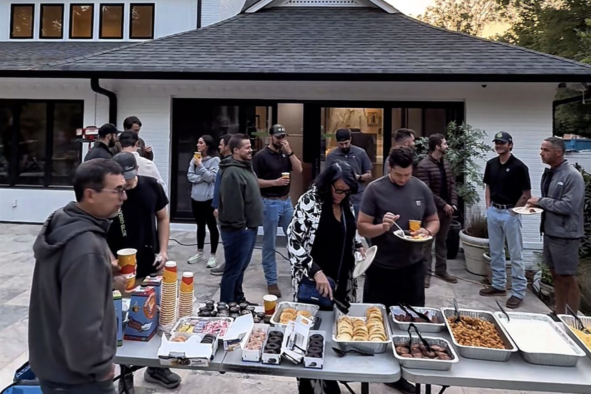 The Revival team and trade partners at a breakfast outside a finished home